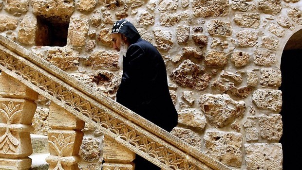 A Syriac priest climbs the stairs at the Syriac Orthodox Mor Gabriel monastery, in Turkish southeastern town of Midyat. Source: AFP/Getty Images/Tarik Tinazay