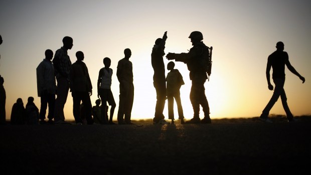 A French soldier checks  passengers of a transport truck arriving  in  Gao, northern Mali, Thursday  Feb. 14, 2013. Malian forces have stepped up security around the port an the main market, in an effort to stop the infiltration of rebel fighters in the town.  (AP Photo/Jerome Delay)