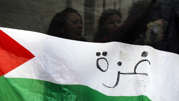 Demonstrators hold a Palestinian flag during a protest outside Jerusalem's magistrates' court in support of Samer Al-Issawi, one of four Palestinians held by Israel who have been on an intermittent hunger strike, February 19, 2013. REUTERS/Ammar Awad