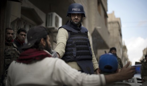 Abu Hussein (C) interviews residents and fighters in a neighbourhood in the eastern Syrian town of Deir Ezzor on February 19, 2013. (AFP PHOTO/ZAC BAILLIE)