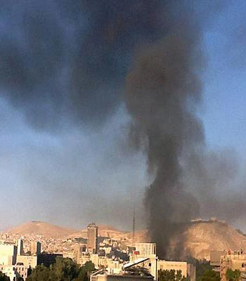 Black smoke rises from Syria's army command headquarters in Damascus. (EPA)