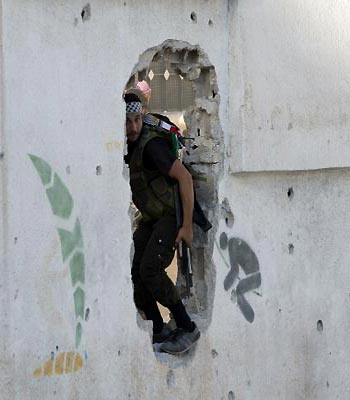 A Syrian rebel fighter arrives to help comrades as they hold their position some 50 meters away from Syrian government troops during fighting in Aleppo's northern Izaa quarter. (AFP)