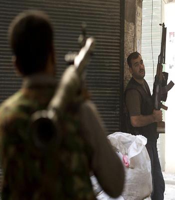 Syrian rebel fighters take their position during fighting with government troops in the old city of Aleppo. (AFP)