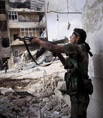 A Free Syrian Army fighter shoots his weapon against Syrian Army positions in Saif al Dawle district, Aleppo, Syria. (EPA)