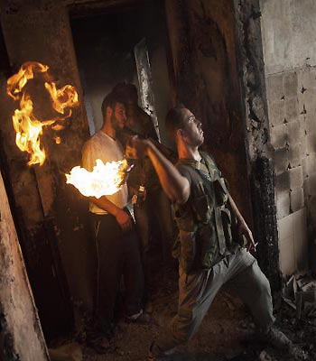 Free Syrian Army soldier throws a petrol bomb towards Syrian Army positions in Saif Al Dawle district in Aleppo, Syria. (AP)