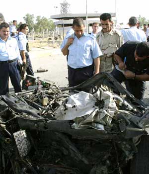 Iraqi police inspects the remains of a car bomb in the northern city of Kirkuk (AFP)