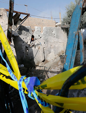 A man looks at the damaged house where five Turkish civilians were killed by a mortar bomb in the southern border town of Akcakale October 4, 2012. (Reuters)