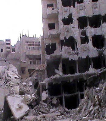 Damaged buildings are seen in Homs.(R)