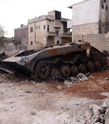 A destroyed military vehicle that belonged to forces loyal to Syria's president Bashar al-Assad is seen abandoned in Kafranbel. (R)