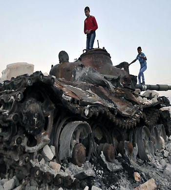 Syrian children play on a destroyed tank in the city of Aleppo. (AFP)