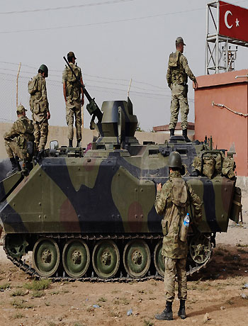 In this Sunday, Oct. 7, 2012 file photo, Turkish military station at the border gate with Syria, across from Syrian rebel-controlled Tel Abyad town, in Akcakale, Turkey. (AP)