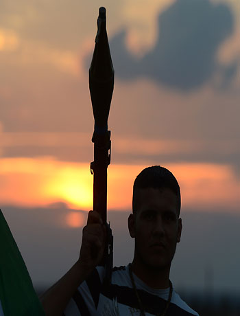 A Syrian rebel holds a rocket-propelled grenade launcher near a post in the rebel-held Syrian city of Minbej on October 10, 2012. (AFP)