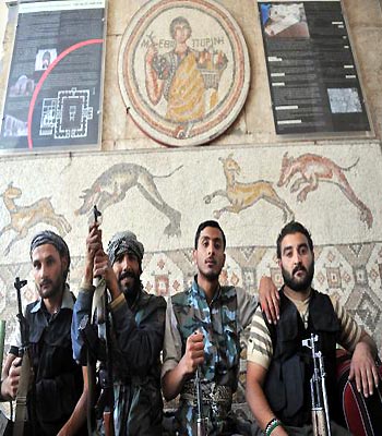 Syrian rebel fighters pose for a picture at the museum of Maaret al-Numan, in the northwestern Idlib province. (AFP)