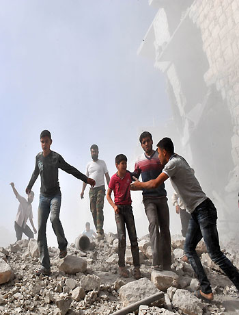 Syria youths react following an airstrike by Syrian government forces in Maaret al-Numaan on October 18, 2012. (AFP)