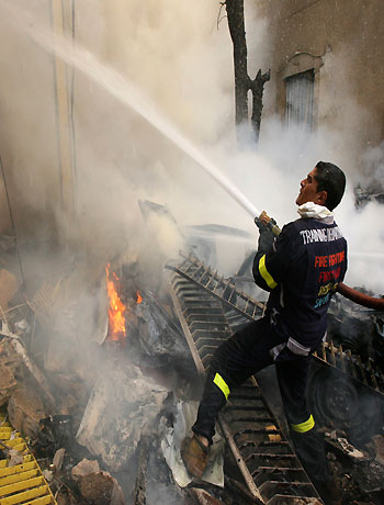 A firefighter tries to put out a fire at the scene of an explosion in Ashafriyeh, central Beirut, October 19, 2012. (Reuters)