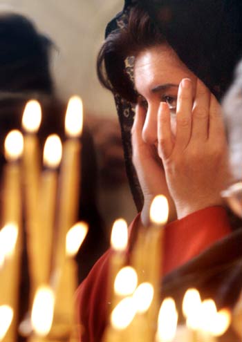 A Jordanian Christian woman reacts during prayers at the Greek Orthodox church in Amman, Jordan (AP)