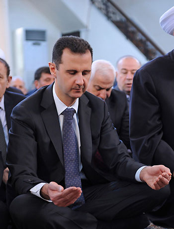 Syria's President Bashar al-Assad performs prayers for Eid al-Adha at al-Afram Mosque in al-Muhajirin area in Damascus October 26, 2012 in this handout photograph released by Syria's national news agency SANA. (Reuters)