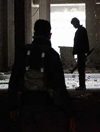 Free Syrian Army fighters are seen inside a building at the front line in Aleppo October 25, 2012. Picture taken October 25, 2012. (Reuters)