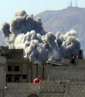 An image grab taken from a video allegedly shows smoke billowing from buildings following shelling by forces loyal to Bashar al-Assad on east Ghouta, near the capital Damascus.(AFP)