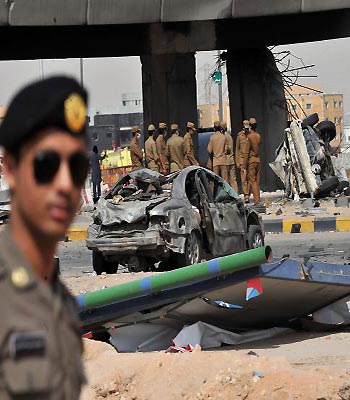 Saudi policemen inspect the destruction under a bridge where a gas tanker truck exploded on a main road in the Saudi capital Riyadh. (AFP)