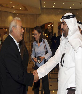 Burhan Ghalioun, leader of the opposition SNC, shakes hands with one of the attendees during the meeting of the General Assembly of the Syrian National Council in Doha.(AP)