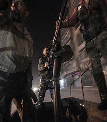A mobile rebel unit moves through rebel-held streets with a truck mounted gun during heavy fighting with Assad loyalists in the Jedida district of Aleppo, Syria. (AP)