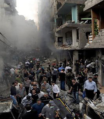 A handout picture released by Syrian Arab News Agency (SANA) shows Syrian citizens gathering at the site of bomb explosion at the Mazzeh Jabal area in Damascus. (SANA)