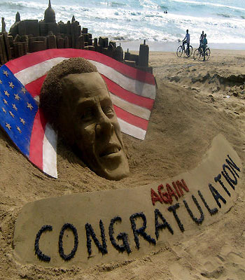 Cyclists look at a sand sculpture of re-elected US President Barack Obama by sand artist Sudarshan Pattnaik at Puri beach, about 70 kms east of the eastern city of Bhubaneswar. (AFP)