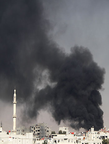 Smoke rises from the eastern Damascus suburbs of Arbeen, after what activists say was an airstrike by a MIG fighter jet, November 8, 2012. (Reuters)