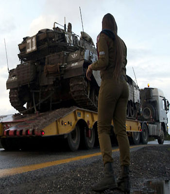 An Israeli soldier overlooks a tank relocation in Alonei Habashan in the Israeli-occupied Golan Heights, on November 11, 2012. (AFP)