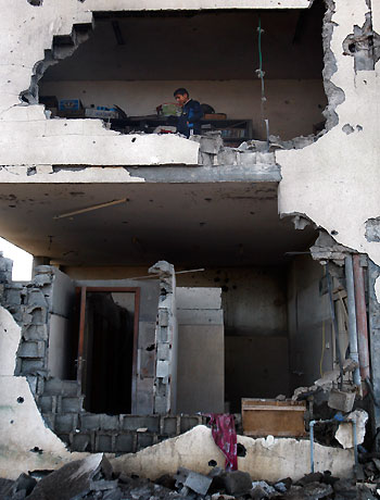 A Palestinian child inspects the damage to a mosque after an Israeli airstrike in Beit Hanoun, north Gaza, Friday, Nov. 16, 2012. (AP)