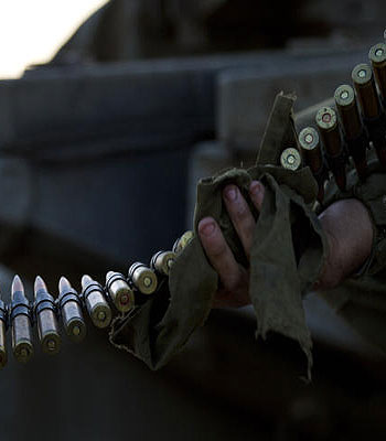An Israeli soldier cleans ammunition as he sits on top of a tank in a staging area near the Israel Gaza Border, southern Israel. (AP)