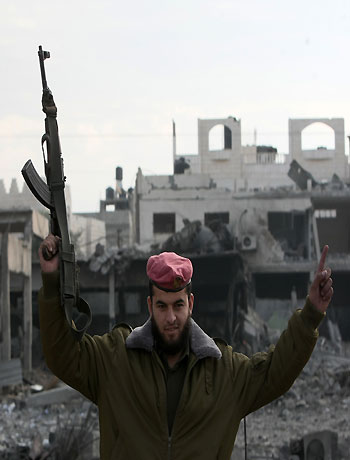 A Hamas policeman celebrates after his return to the Palestinian movement's destroyed Al-Saraya headquarters in Gaza City November 22, 2012, a day after a cease fire was declared. (AFP)