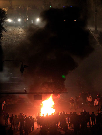 Demonstrators set fire during clashes at Tahrir Square in Cairo November 23, 2012. (Reuters)