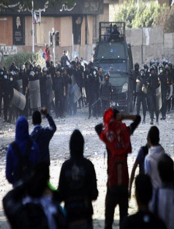 Protesters face Egyptian riot Police during clashes on Omar Makram street, off Tahrir Square, on November 28, 2012 in Cairo. (AFP)