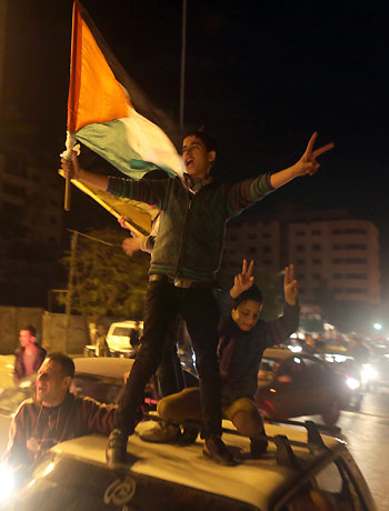 Palestinians celebrate in Gaza City early on November 30, 2012, after the UN General Assembly voted to upgrade them to a non-member state observer.(AFP)