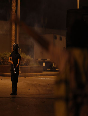 Riot police officers release tear gas during clashes with anti-Mursi protesters in front of the presidential palace in Cairo, December 4, 2012. (Reuters)