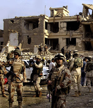 Iraqi soldiers secure the site where two suicide bombers detonated explosives-laden cars near a Baghdad hotel and an interior ministry complex, 18 November, 2005 (AFP)