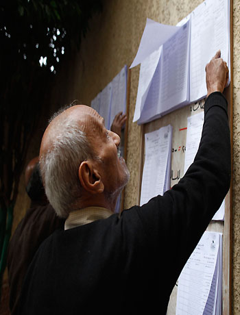 A man looks for his name at a polling station before casting his vote during a referendum on Egypt's new constitution in Cairo December 15, 2012. (Reuters)