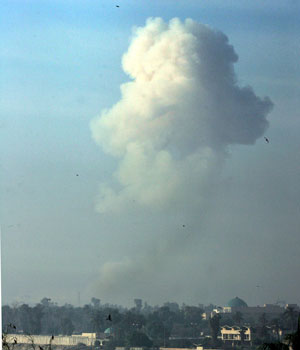 A mushroom cloud rises after two car bombs shook central Baghdad, Iraq, Nov. 18, 2005, near an Interior Ministry building where U.S. troops found detainees showing signs of torture, police said (AP)