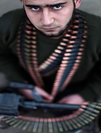 In this Monday, Dec. 17, 2012 photo, Syrian rebel fighter Ibrahim Iaaa, 20, a former construction worker, poses for a picture following a training session in Maaret Ikhwan, near Idlib, Syria. (AP)
