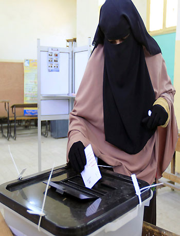 A woman casts her ballot at a polling centre during the final stage of a referendum on Egypt's new constitution in the El Arbeen district of Suez, 120 km (75 miles) away from Cairo, December 22, 2012. (Reuters)