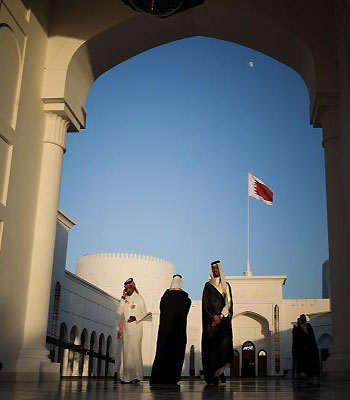 Men walk along the corridor at the Sakhir Palace in Manama, on December 24, 2012, as delegates attend the annual Gulf Cooperation Council (GCC) summit. (AFP)