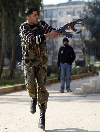 A Free Syrian Army fighter fires at a sniper loyal to Syrian President Bashar el-Assad during a fight on the front line in Aleppo city December, 31, 2012. (Reuters)