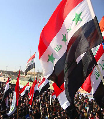 Iraqis wave their national flag during a sit-in by citizens, clergy, tribal leaders and MPs, in the northern city of Samarra, in Salaheddin province, close to the Razzaq central mosque. (AFP)