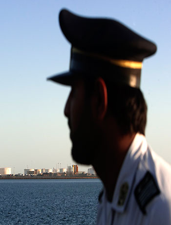 A security officer looks on at oil docks at the port of Kalantari in the city of Chabahar, 300km (186 miles) east of the Strait of Hormuz in this January 17, 2012 file photo. (Reuters)