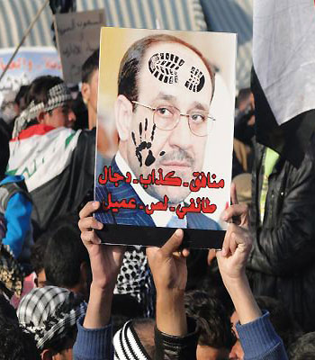 Iraqi Sunni protestors hold up a portrait of Prime Minister Nuri al-Maliki with slogans reading in Arabic, "liar...sectarian, thief, collaborator" during a protest in west Baghdad. (AFP)