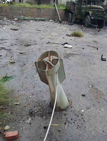 An unexploded ordnance is seen near damaged military trucks belonging to forces loyal to Syria's President Bashar al-Assad in Muderyia, near Damascus, January 6, 2013 in this picture provided by Shaam News Network. (Reuters)