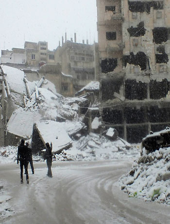 Free Syrian Army members patrol Jouret al Shayah area during a snowstorm in Homs January 9, 2013. (Reuters)