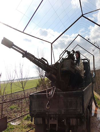 Members of the fighting vanguard, one of several Islamic brigades part of Free Syrian Army, besieging Taftanaz air base near Idlib, man a weapon in this picture provided by Shaam News Network January 9, 2013. (Reuters)